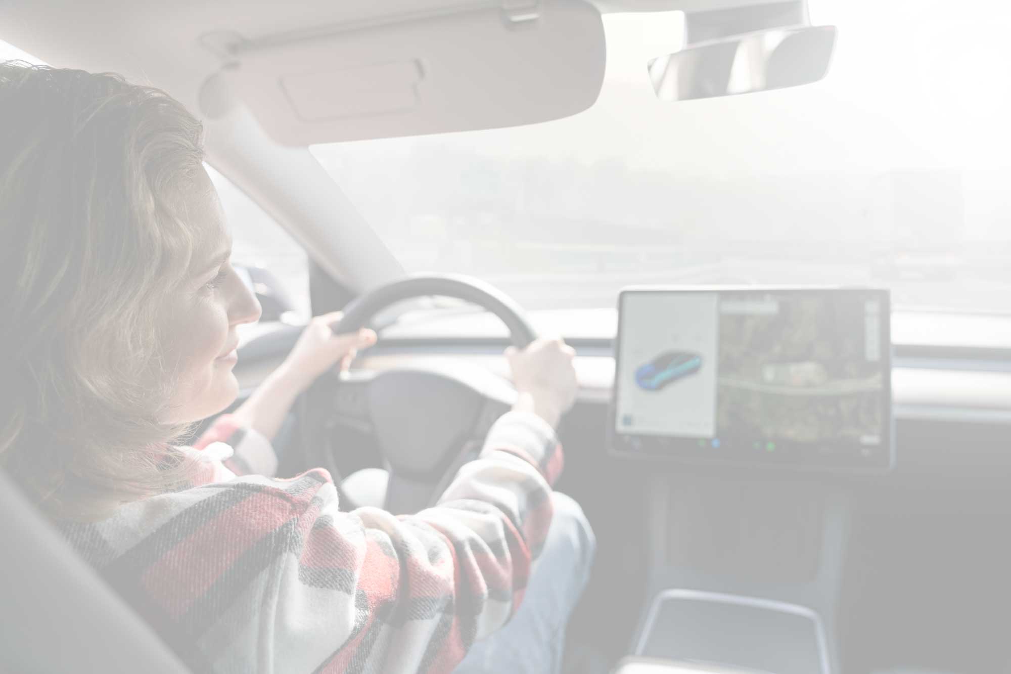 A woman driving a car.